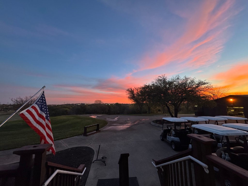 Golf carts park during sunset 